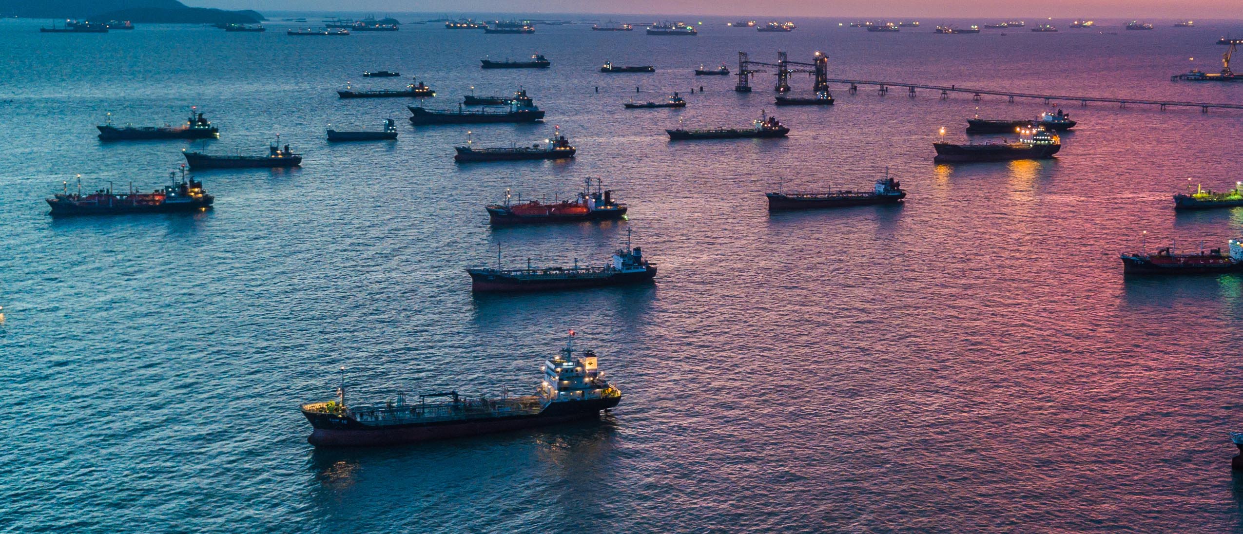 Slow Steaming Ships vs Vessels at Anchor